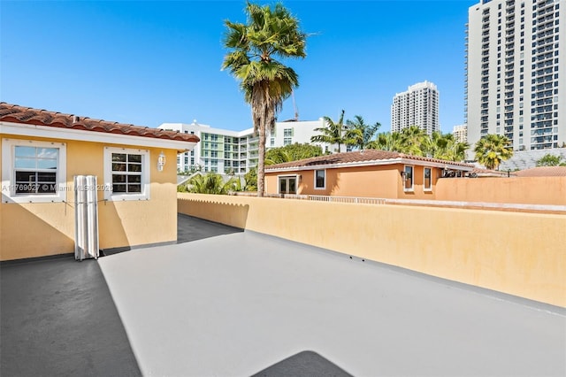 view of patio featuring a view of city and fence