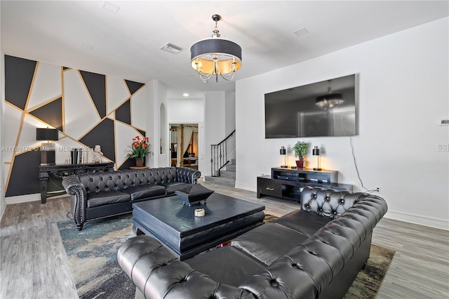 3007 W 8th St, Lehigh Acres, FL 33971 - living area with stairway, baseboards, wood finished floors, and a chandelier