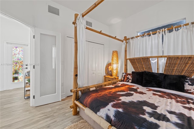 3007 W 8th St, Lehigh Acres, FL 33971 - bedroom with light wood-style flooring and a barn door