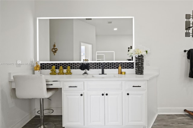 3007 W 8th St, Lehigh Acres, FL 33971 - bathroom with baseboards, wood finished floors, and vanity