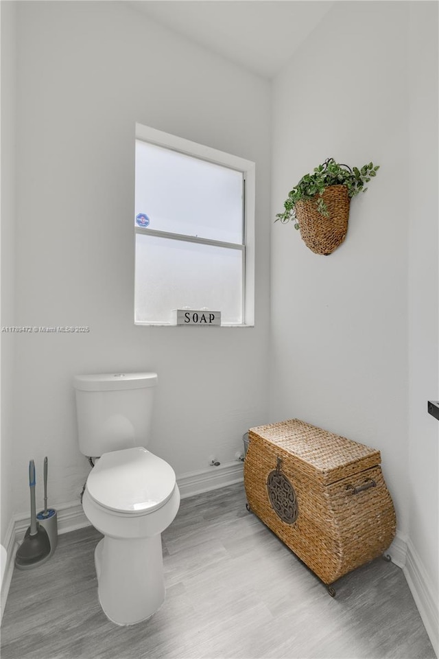 3007 W 8th St, Lehigh Acres, FL 33971 - bathroom featuring baseboards, toilet, and wood finished floors