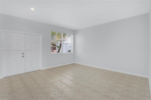 unfurnished room featuring tile patterned floors, baseboards, and recessed lighting