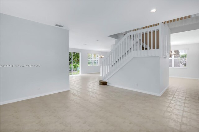 spare room with baseboards, visible vents, recessed lighting, a chandelier, and stairway