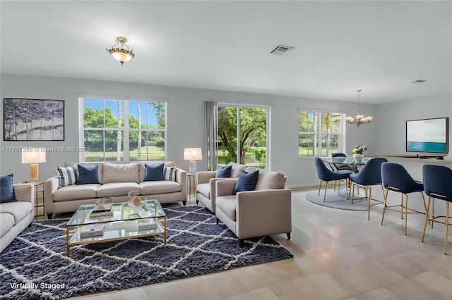 living area with an inviting chandelier and visible vents