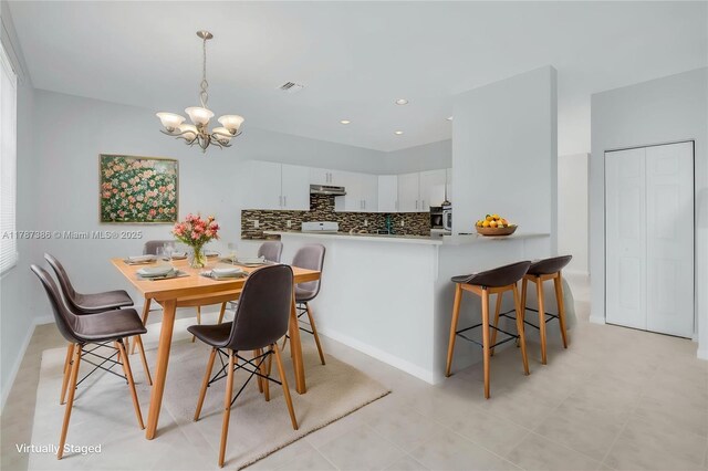 dining space with light tile patterned floors, recessed lighting, visible vents, and a chandelier