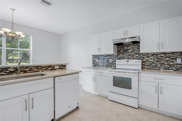 1042 Bluewood Ter, Weston, FL 33327 - kitchen with under cabinet range hood, white appliances, a sink, backsplash, and light countertops
