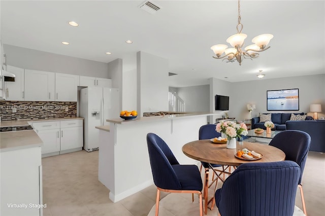 dining room featuring recessed lighting, visible vents, and a chandelier