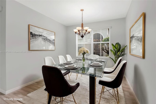 1042 Bluewood Ter, Weston, FL 33327 - dining space featuring wood finished floors, a chandelier, and baseboards