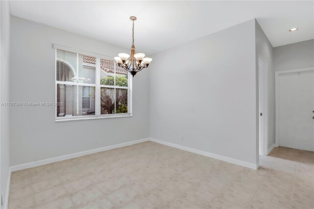 unfurnished room with baseboards, an inviting chandelier, and recessed lighting
