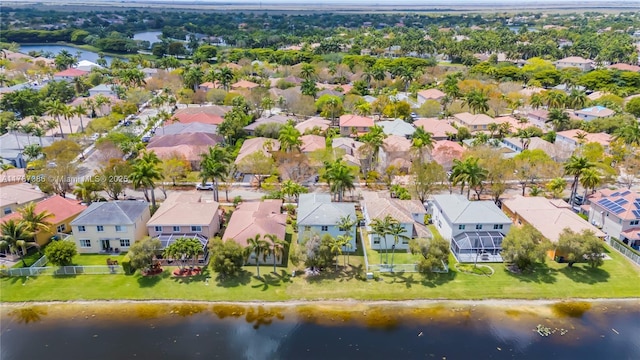 drone / aerial view featuring a water view and a residential view
