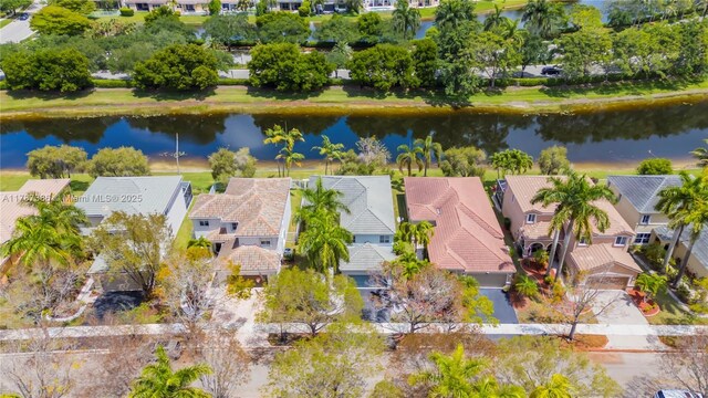 drone / aerial view with a residential view and a water view