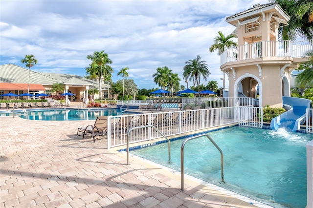 1042 Bluewood Ter, Weston, FL 33327 - community pool with a water slide and a patio