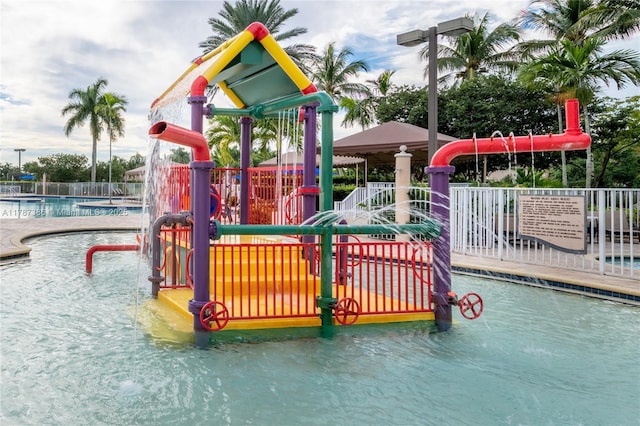 1042 Bluewood Ter, Weston, FL 33327 - view of playground featuring a water play area and a community pool