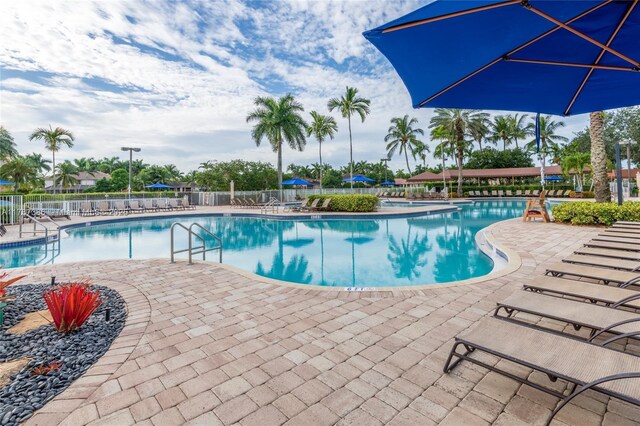 pool featuring fence and a patio
