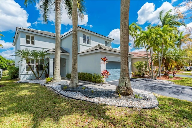 1042 Bluewood Ter, Weston, FL 33327 - mediterranean / spanish house featuring stucco siding, asphalt driveway, a front lawn, an attached garage, and a tile roof
