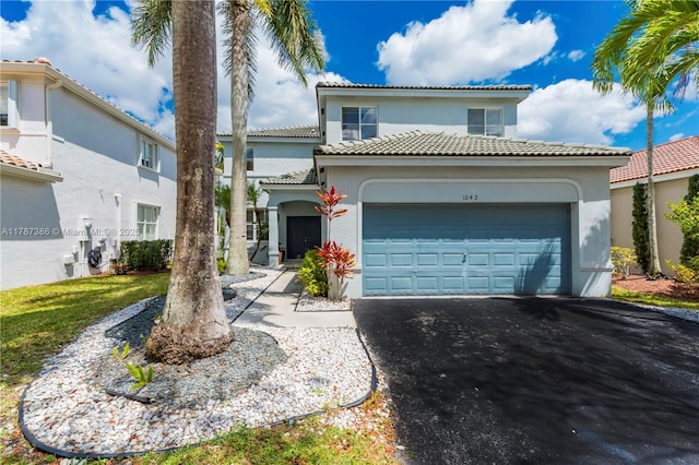 1042 Bluewood Ter, Weston, FL 33327 - mediterranean / spanish-style house featuring stucco siding, a garage, driveway, and a tile roof