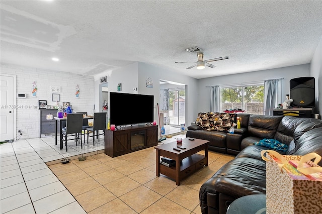 4210 NW 23rd St, Lauderhill, FL 33313 - living area featuring a ceiling fan, a textured ceiling, visible vents, and light tile patterned floors