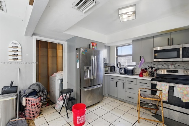4210 NW 23rd St, Lauderhill, FL 33313 - kitchen with washer / dryer, visible vents, appliances with stainless steel finishes, and gray cabinetry