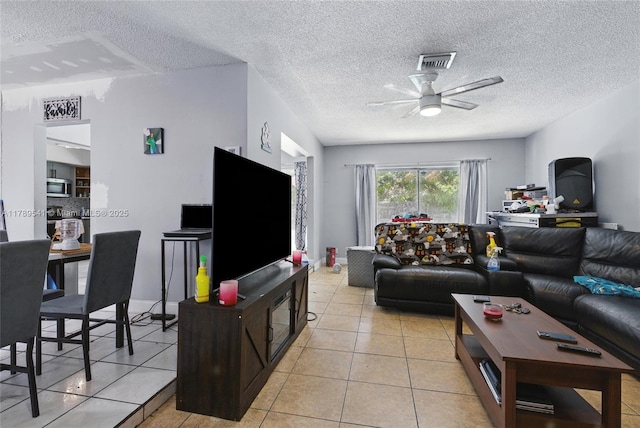 4210 NW 23rd St, Lauderhill, FL 33313 - living room with a ceiling fan, a textured ceiling, visible vents, and light tile patterned floors