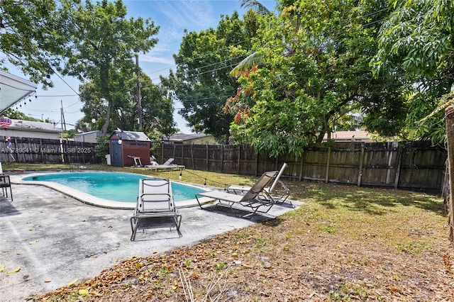 4210 NW 23rd St, Lauderhill, FL 33313 - view of swimming pool featuring a storage shed, an outbuilding, a fenced backyard, a patio area, and a yard