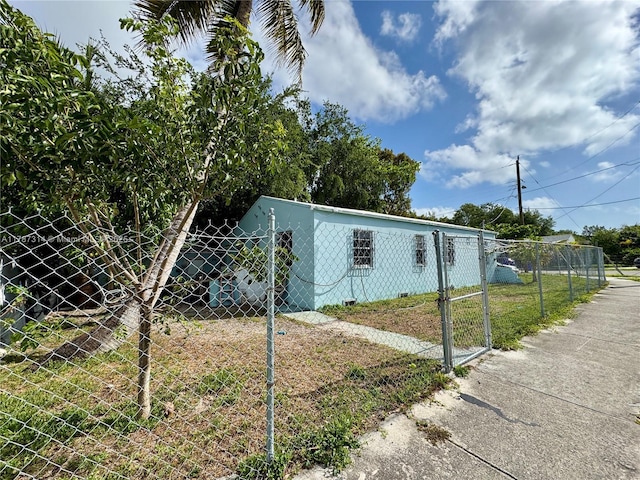 view of home's exterior with a gate and fence