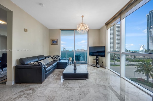 living area featuring plenty of natural light, a chandelier, and floor to ceiling windows