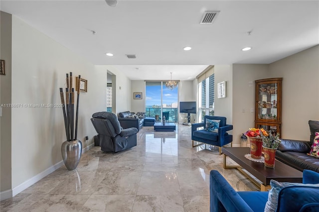 living room featuring recessed lighting, marble finish floor, baseboards, and an inviting chandelier
