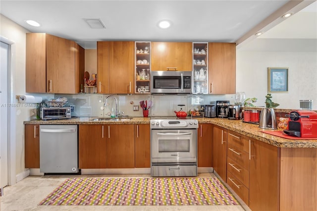 1945 S Ocean Dr Unit 401, Hallandale Beach, FL 33009 - kitchen with stainless steel appliances, brown cabinets, open shelves, and recessed lighting