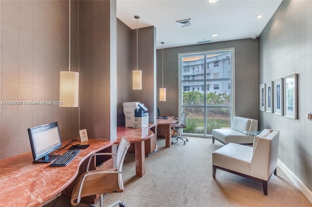 office featuring carpet floors, visible vents, and tile walls
