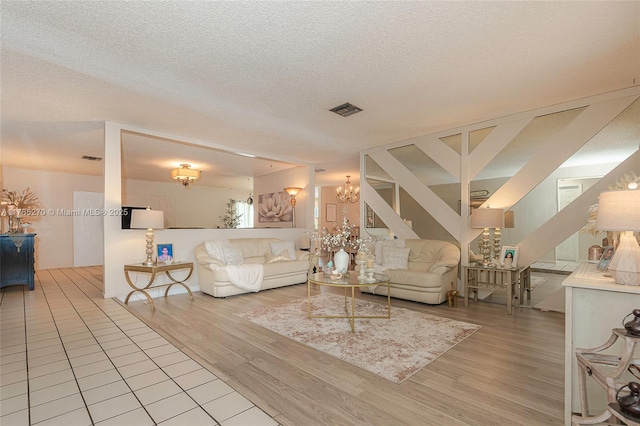 11430 NW 39th Ct, Coral Springs, FL 33065 - living room with stairs, wood finished floors, a textured ceiling, and visible vents