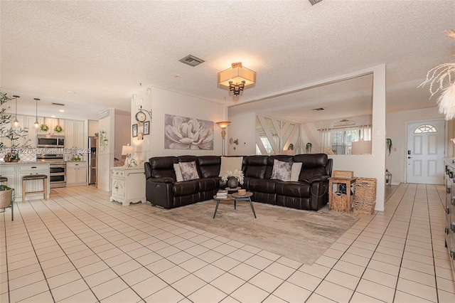 11430 NW 39th Ct, Coral Springs, FL 33065 - living room with light tile patterned flooring, a textured ceiling, and visible vents