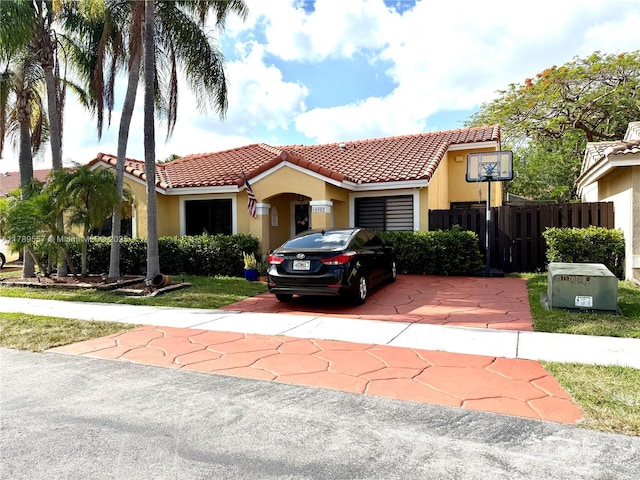 15357 SW 43rd Ter, Miami, FL 33185 - view of front of property with a tiled roof, stucco siding, an attached garage, concrete driveway, and fence