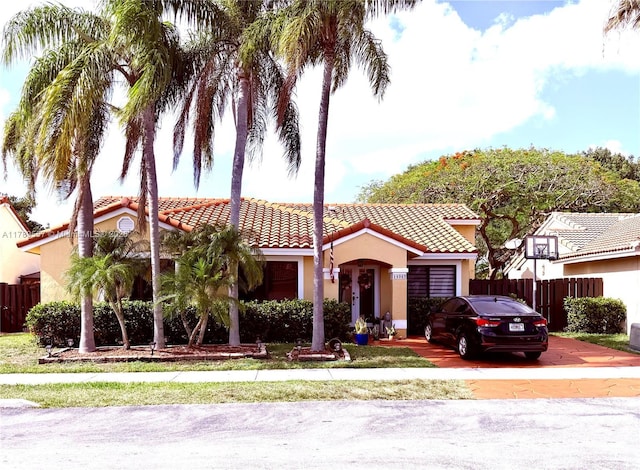 15357 SW 43rd Ter, Miami, FL 33185 - mediterranean / spanish home with stucco siding, a tile roof, fence, an attached garage, and driveway