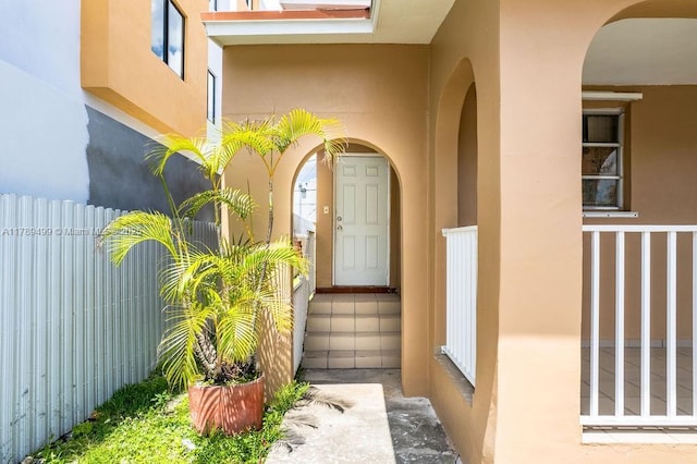 doorway to property featuring stucco siding