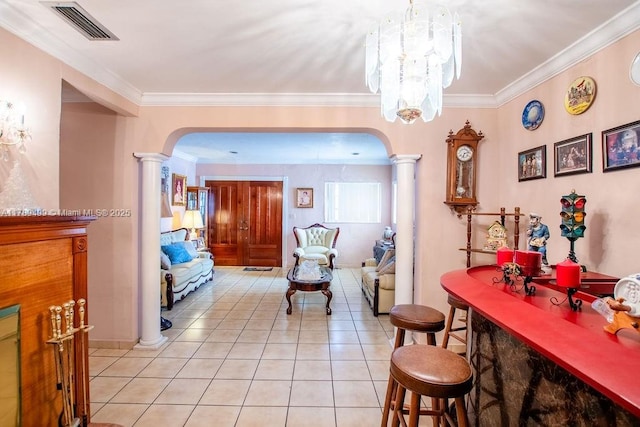 dining room featuring arched walkways, visible vents, ornate columns, and ornamental molding