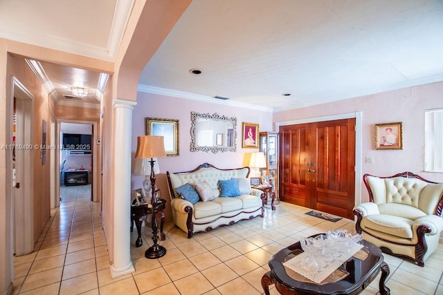 living area with light tile patterned floors, arched walkways, crown molding, and decorative columns
