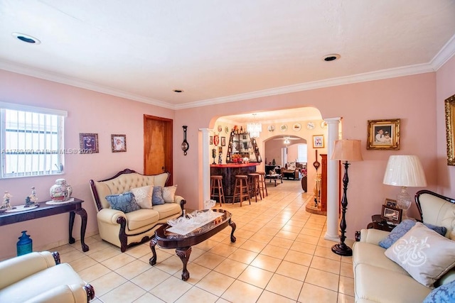 living room with arched walkways, ornamental molding, and light tile patterned floors