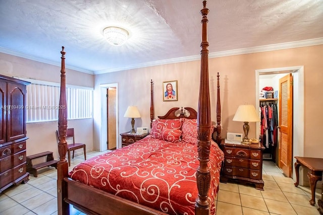 bedroom with crown molding, a spacious closet, a closet, and light tile patterned flooring