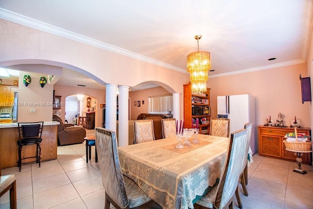 dining area with arched walkways, a notable chandelier, and light tile patterned floors