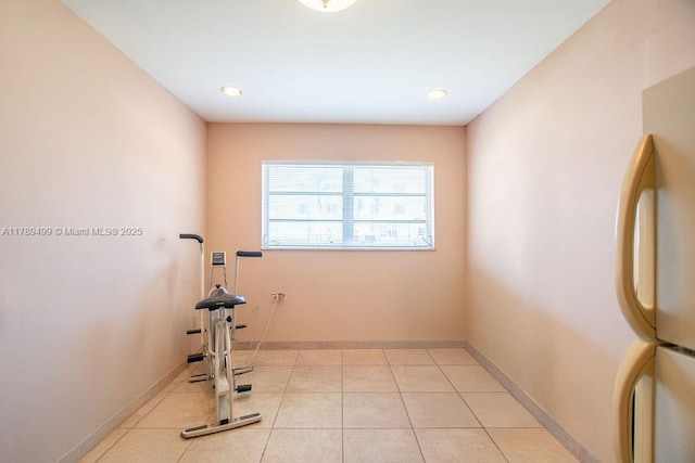 exercise area with recessed lighting, baseboards, and light tile patterned floors