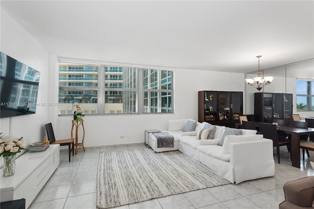 living area with a notable chandelier and light tile patterned flooring