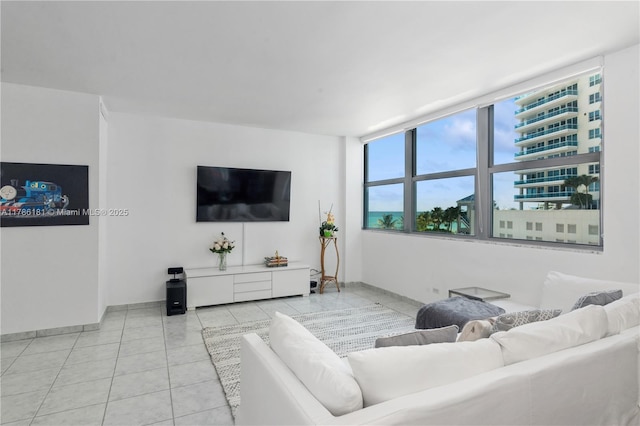 living area featuring baseboards and tile patterned flooring