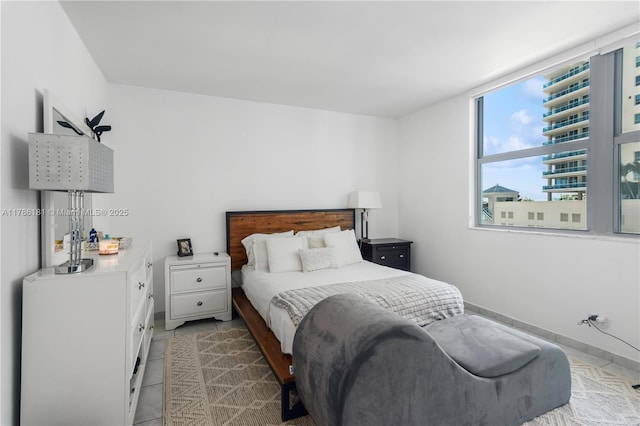 5055 Collins Ave Unit 5F, Miami Beach, FL 33140 - bedroom with baseboards and light tile patterned flooring