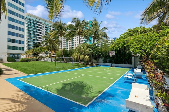 view of tennis court featuring community basketball court and fence