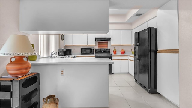 10132 NW 4th, Plantation, FL 33324 - kitchen featuring under cabinet range hood, light countertops, visible vents, black appliances, and a peninsula