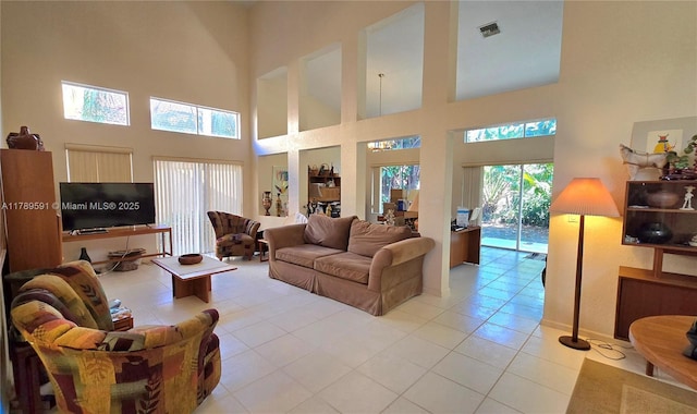 10132 NW 4th, Plantation, FL 33324 - living room featuring visible vents, light tile patterned flooring, and a towering ceiling