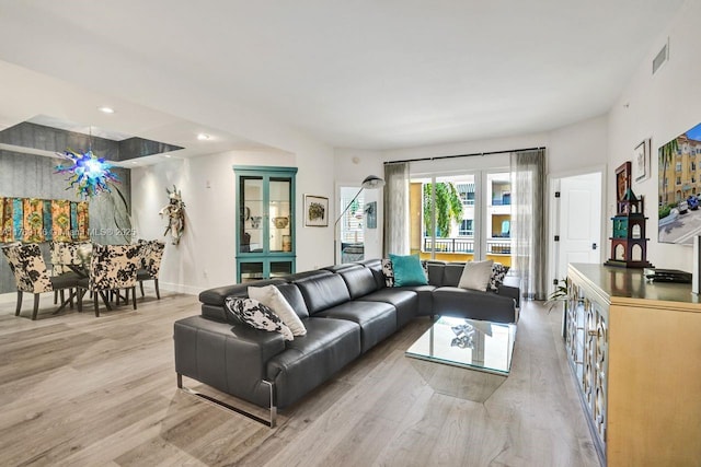 living room with visible vents, recessed lighting, light wood-style floors, and baseboards