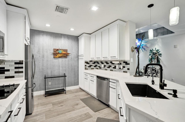 16101 Emerald Estates Dr Unit 342, Weston, FL 33331 - kitchen with a sink, light stone counters, visible vents, white cabinetry, and appliances with stainless steel finishes
