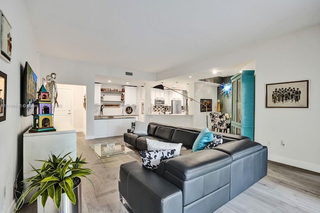 living area with light wood-style floors and baseboards