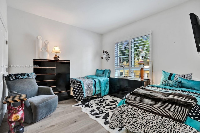 bedroom with wood finished floors